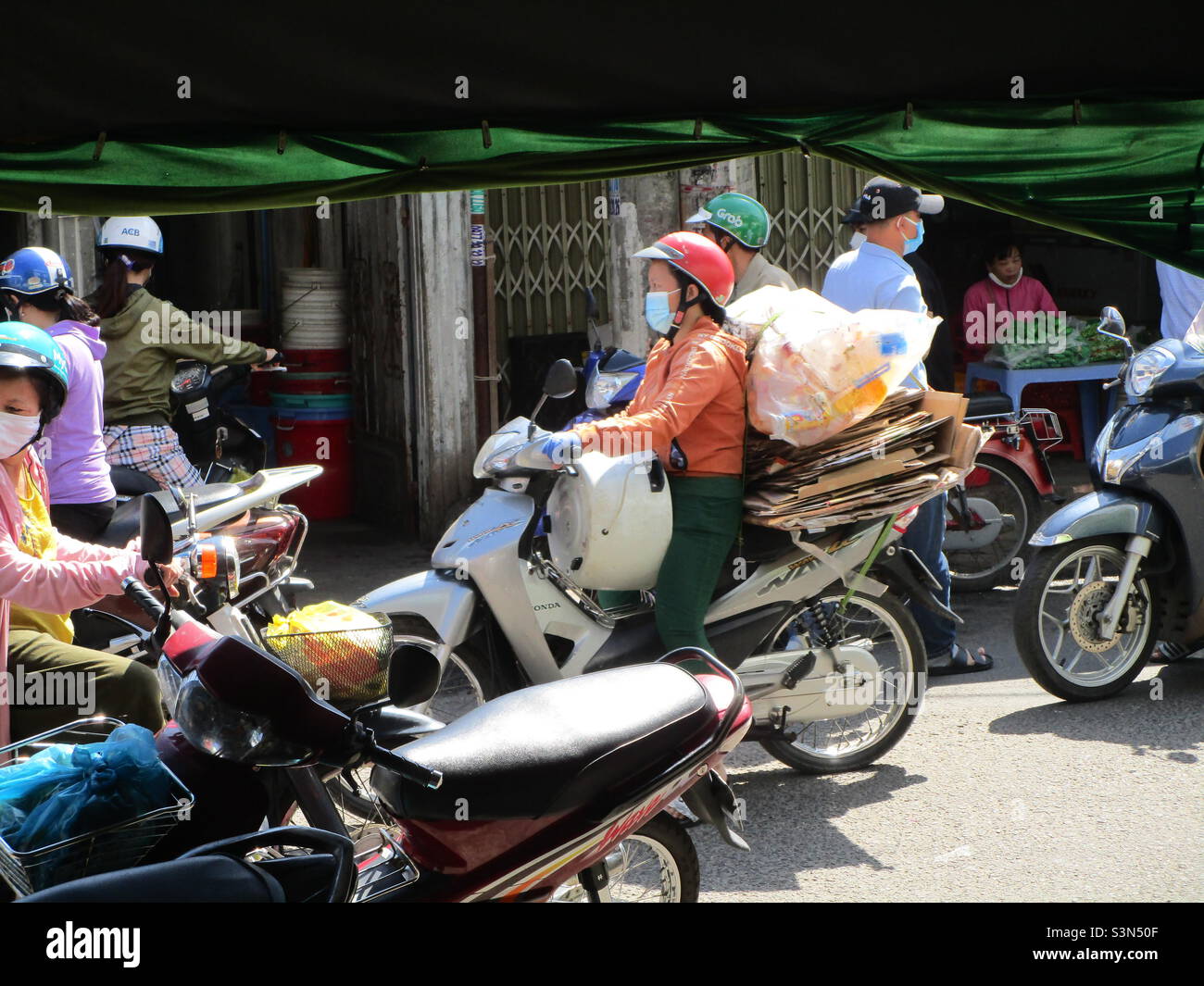 Street Police (in blue shirt) inspect flower shops on Le Van Phan Street, Phu Thuy, Phan Thiet, Binh Thuan, Vietnam (29 January 2022 at 11h35) - Smartphone Captured Stock Image