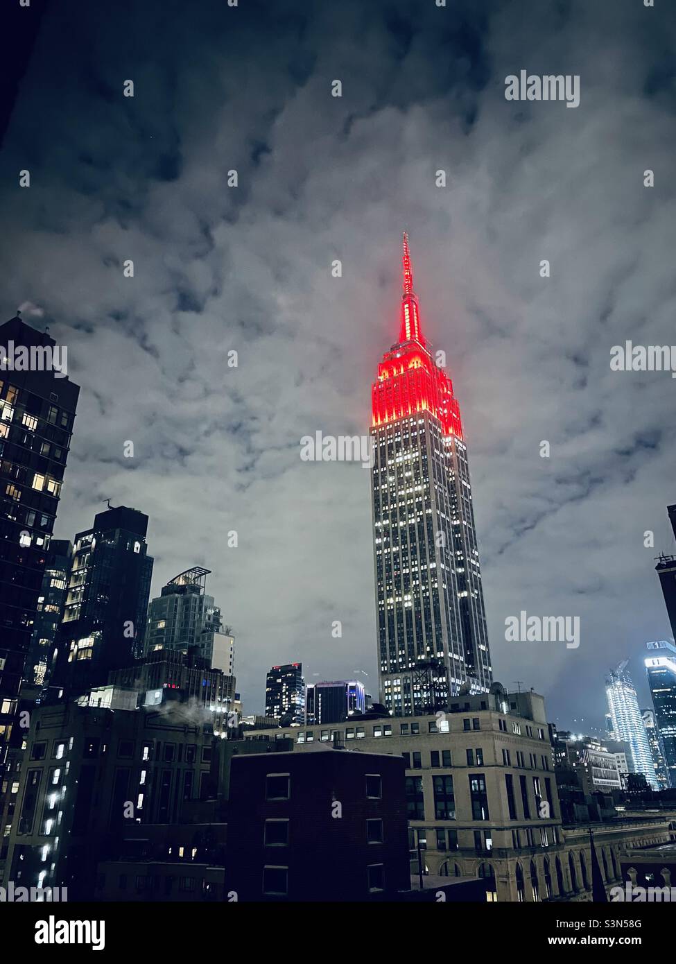 The tower lights on the empire state building glow bright red to honor the Chinese new year - Smartphone Captured Stock Image
