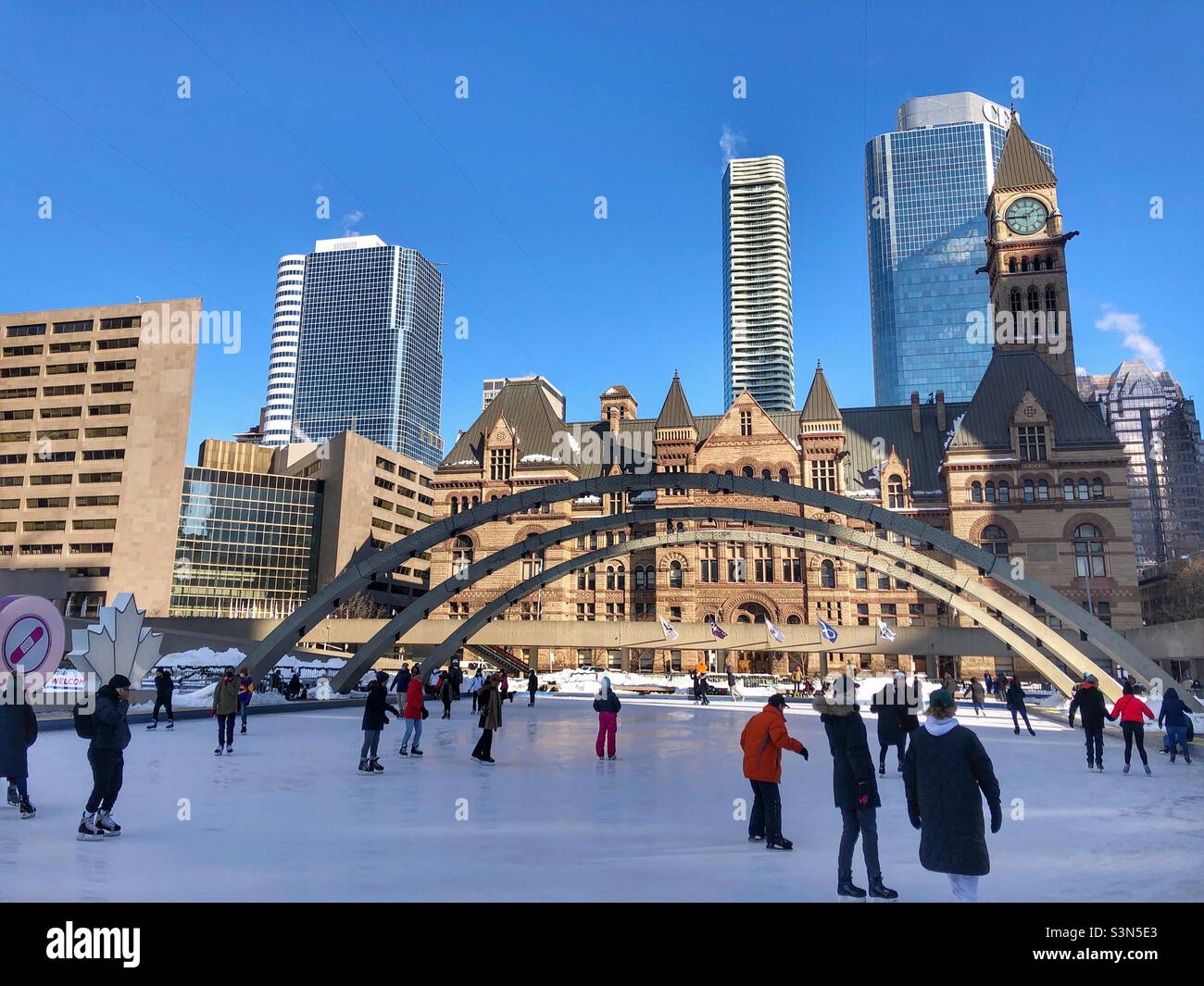 Downtown Toronto on a sunny winter day and people skating at Nathan Phillips Square. - Smartphone Captured Stock Image