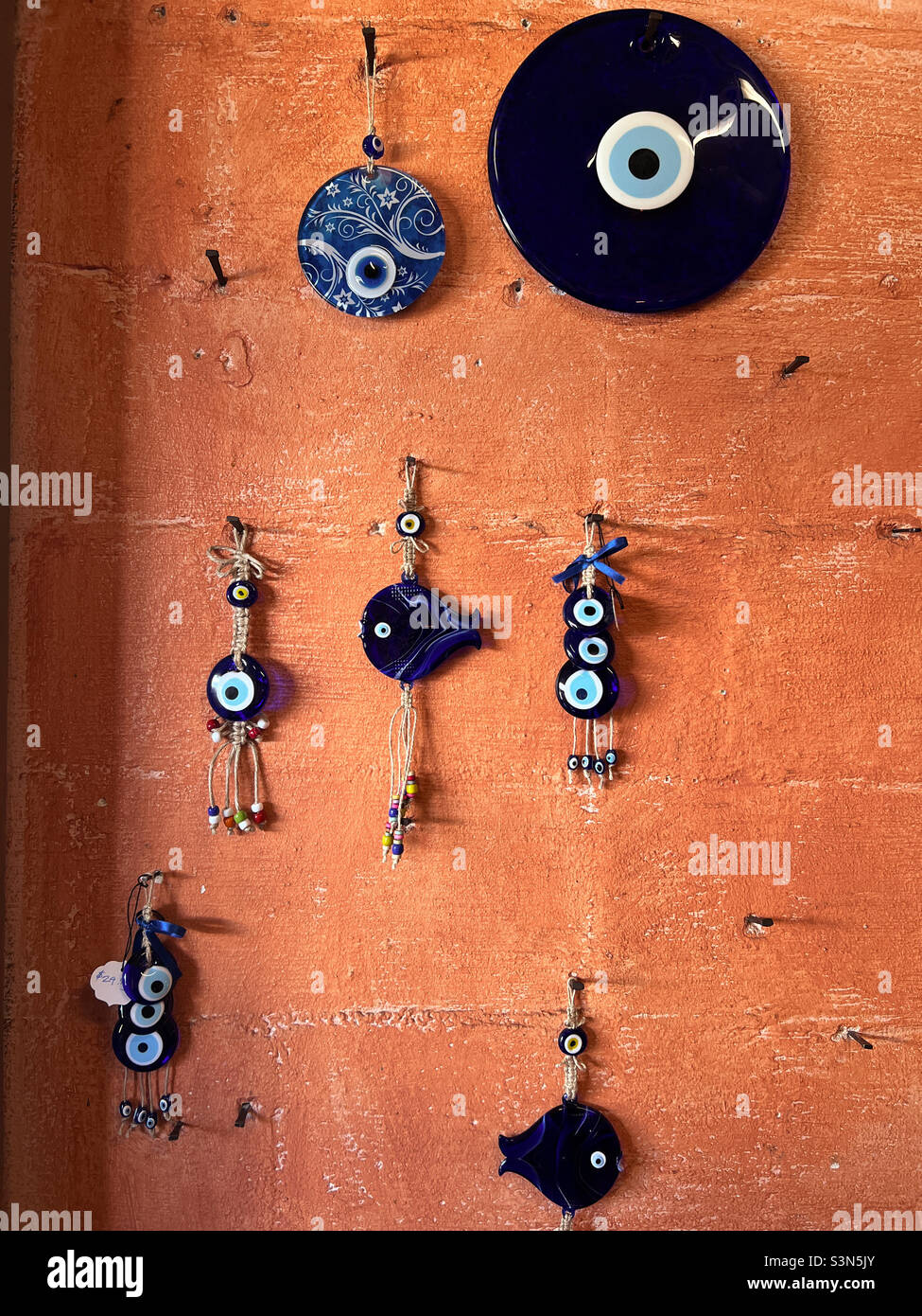 The Greek word Matiasma for Evil Eye” or is used to describe the symbol of the evil eye. These matiasma’s will help fend off the evil “Mati” or eye. Tarpon Springs, Florida. - Smartphone Captured Stock Image