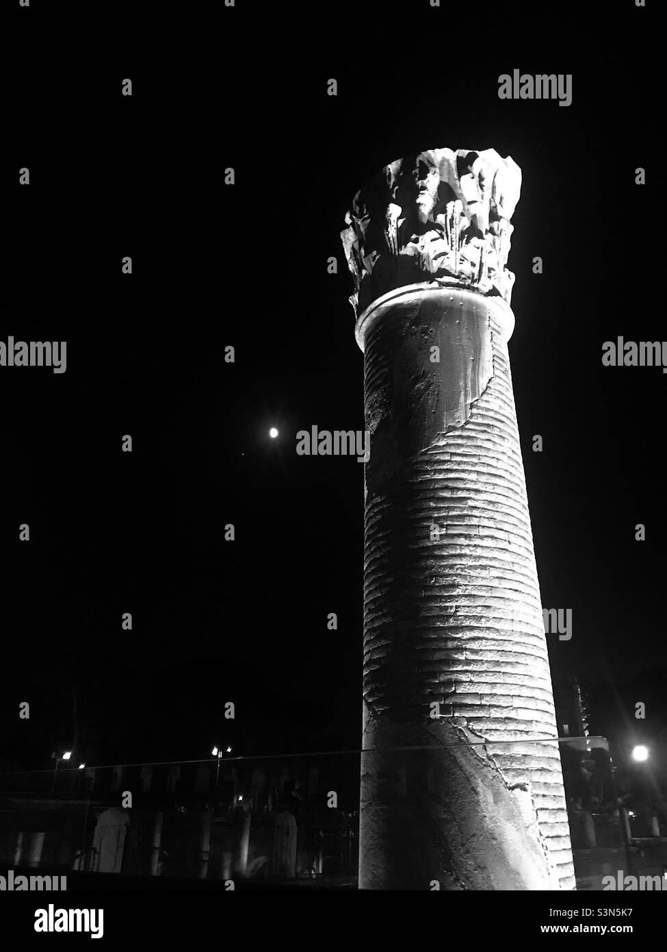 A column in Trajan’s Forum in Rome, Italy with the moon in the background. - Smartphone Captured Stock Image