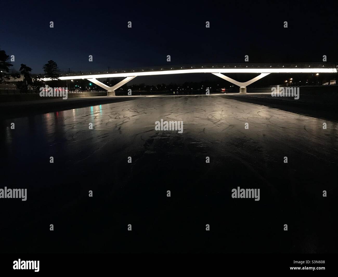 The Flora footbridge lit up on a crisp morning on the Rideau Canal Skateway. - Smartphone Captured Stock Image The Flora footbridge lit up on a crisp morning on the Rideau Canal Skateway. - Smartphone Captured Stock Image