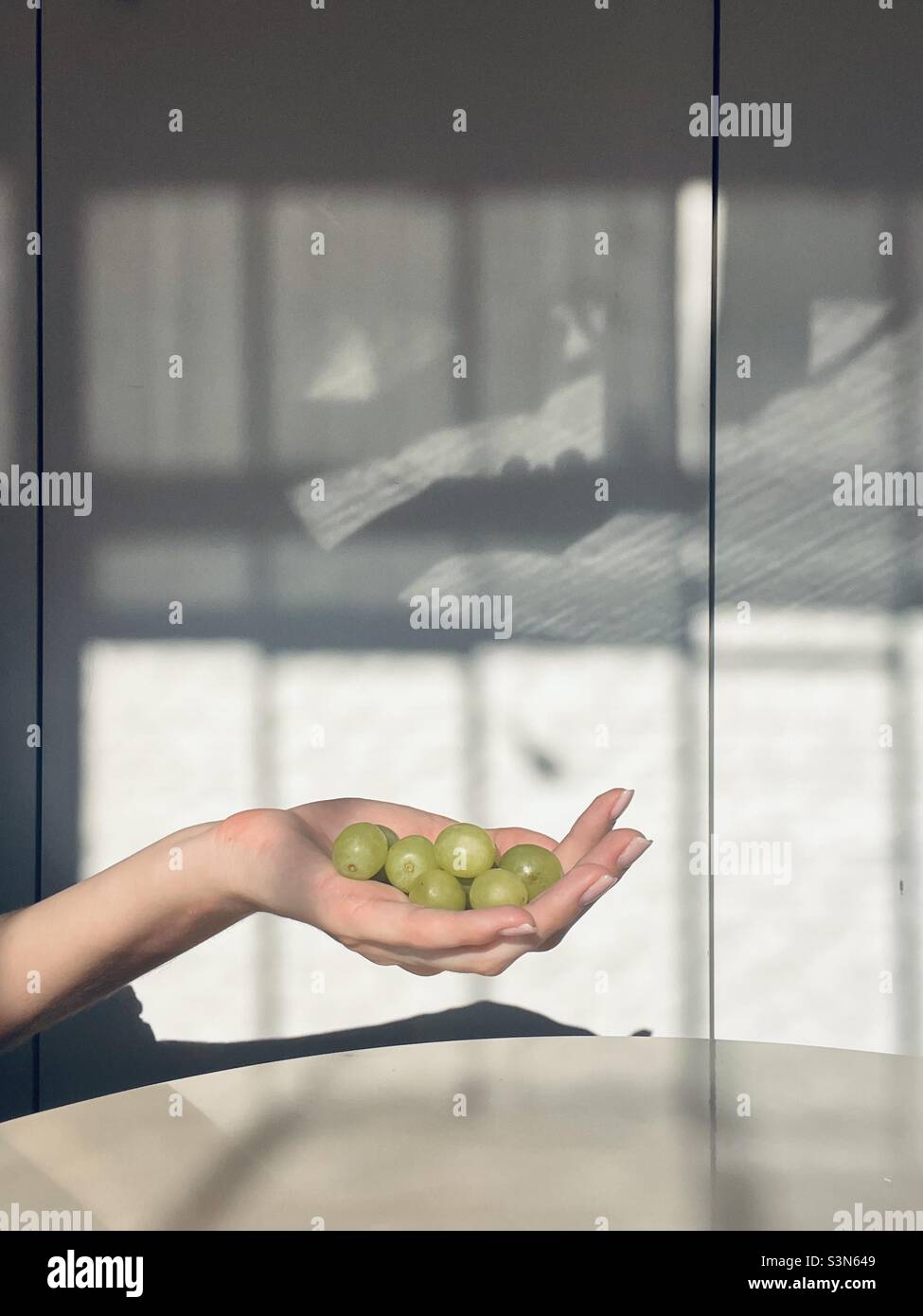 Green grapes in the hand. Minimalism - Smartphone Captured Stock Image