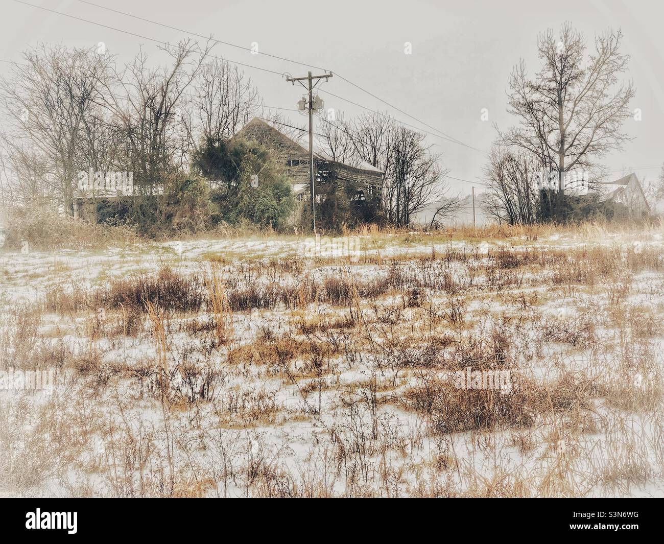 Dilapidated barn in snowy field- January in North Carolina Stock Photo
