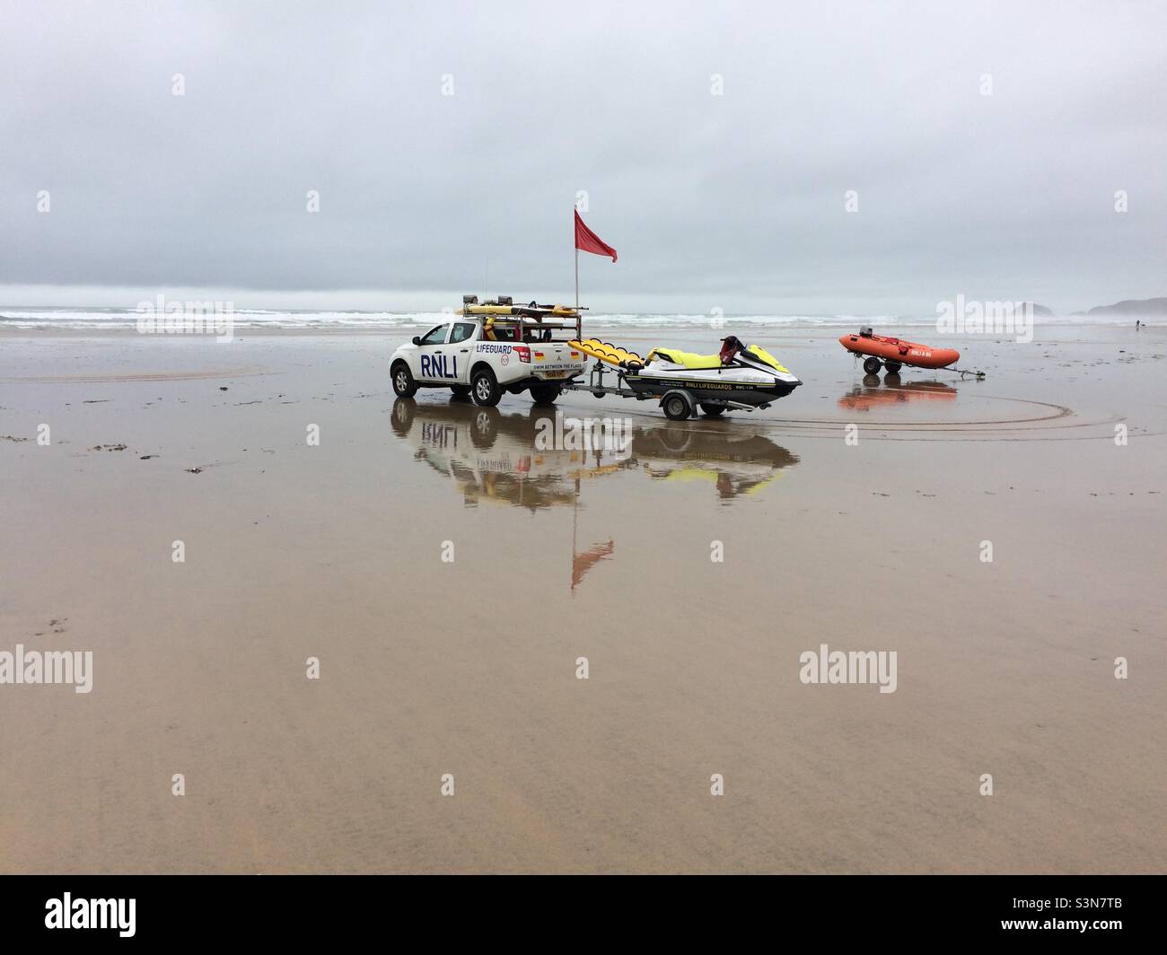 RNLI lifeguards red flag on Perranporth Beach, Cornwall - Smartphone Captured Stock Image