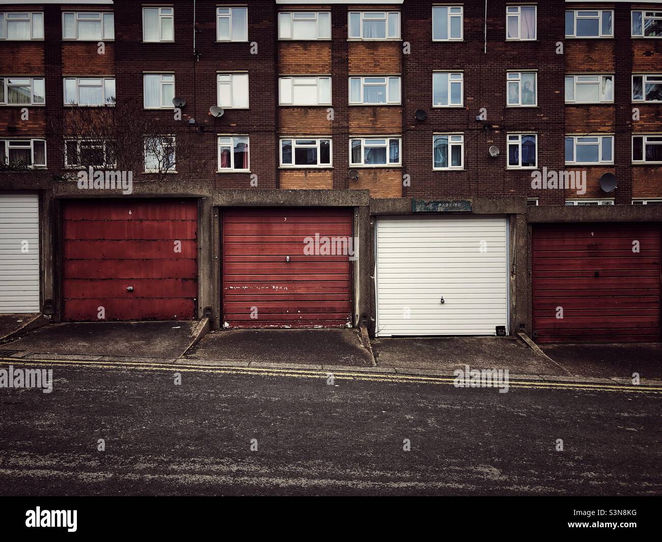 Rundown apartment blocks and flats with garages in the back streets of the north of England Stock Photo