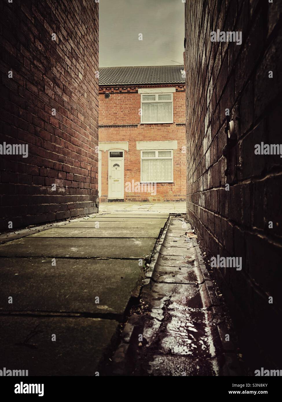 A view of a rundown terraced house from a back alleyway in the north of England with copy space Stock Photo