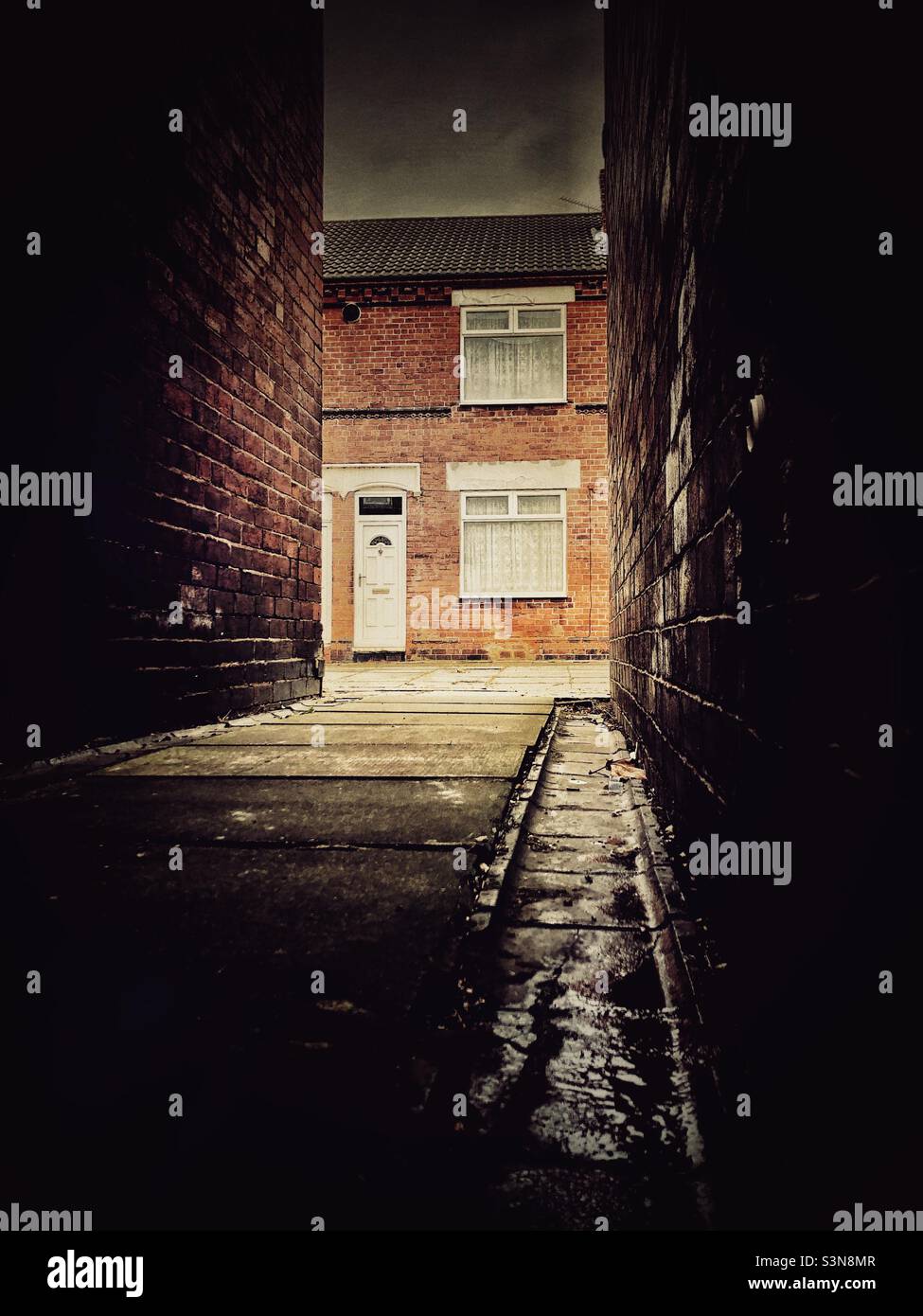 Rundown back streets and alleyways of a terraced house estate in the north of England with copy space Stock Photo