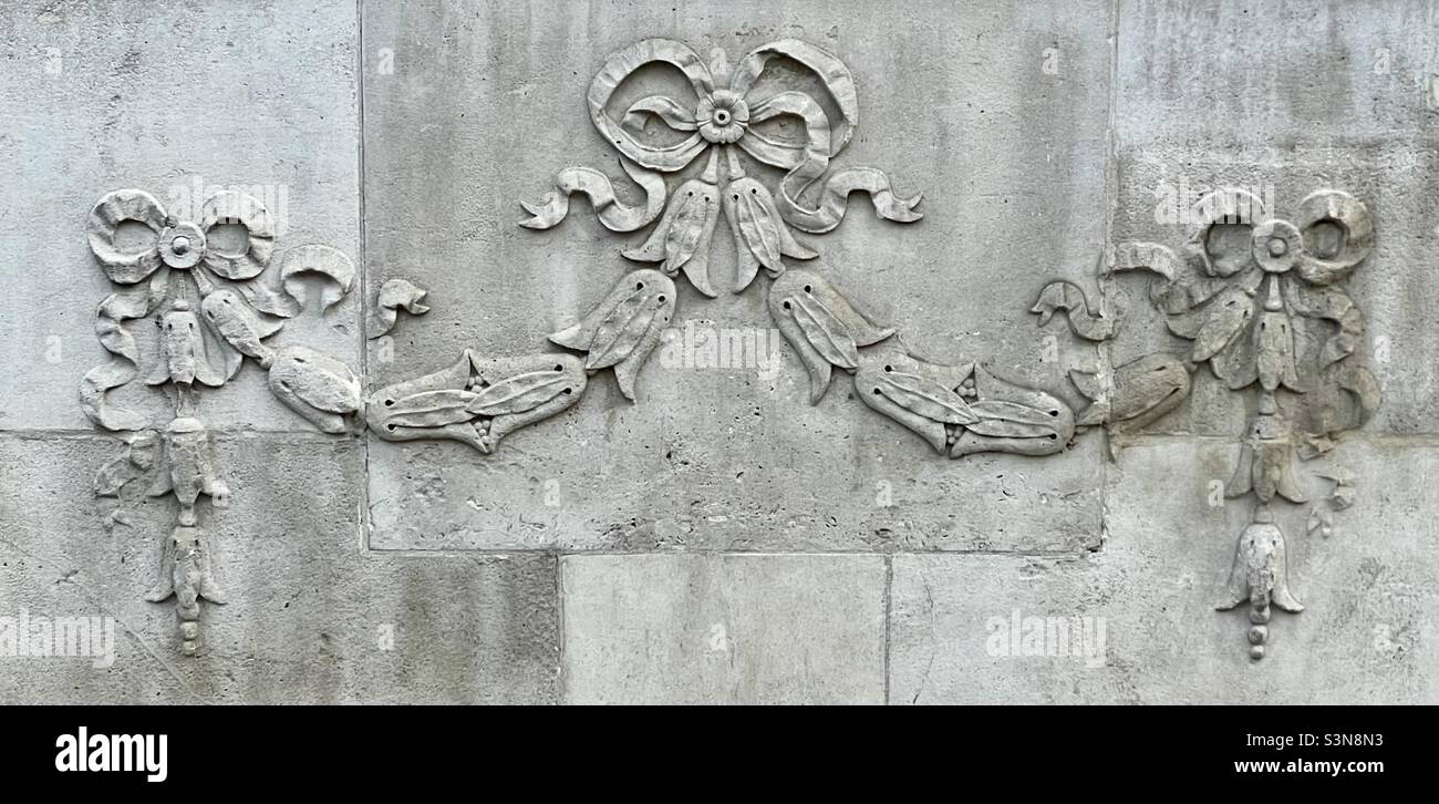 A decorative detail carved in relief on the front of an old bank building in Worcester’s high street - Smartphone Captured Stock Image