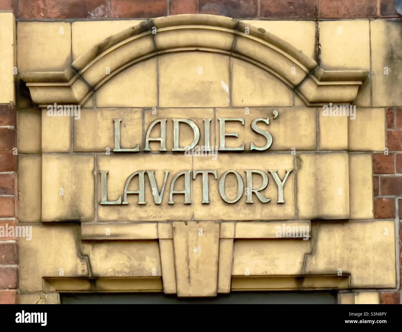 Buff coloured tile work above the entrance to a ladies toilet in Worcester - Smartphone Captured Stock Image