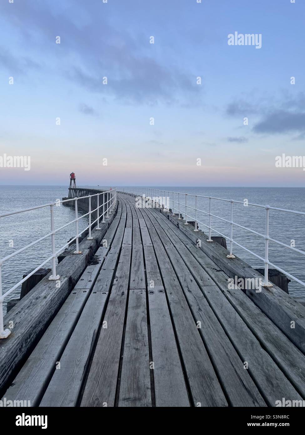 Wooden pier. Curve. Stillness. Whitby Stock Photo