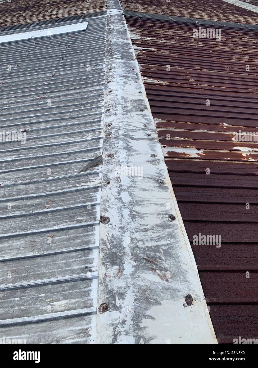 Rusting zinc roofing next to one in good condition Stock Photo Alamy
