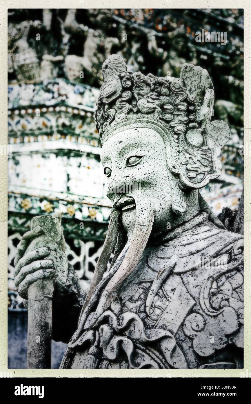 A guardian statue outside Wat Arun in Bangkok, Thailand Stock Photo