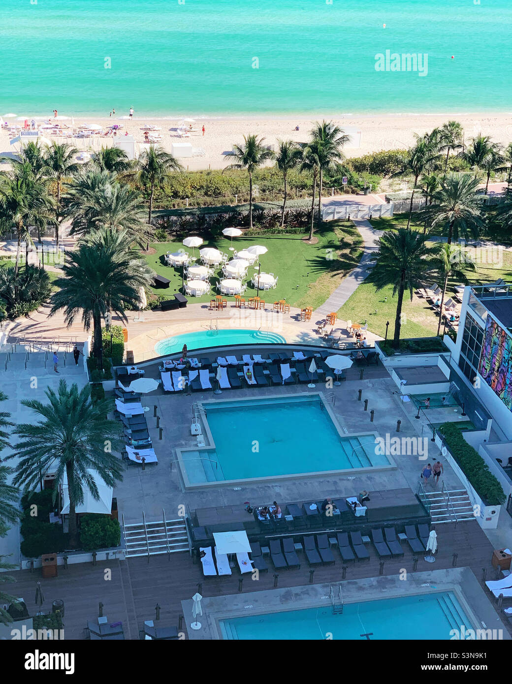 December, 2021, view of pools and the beach at Eden Roc and Nobu Hotel, Mid-beach, Miami Beach, Florida, United States, North America - Smartphone Captured Stock Image