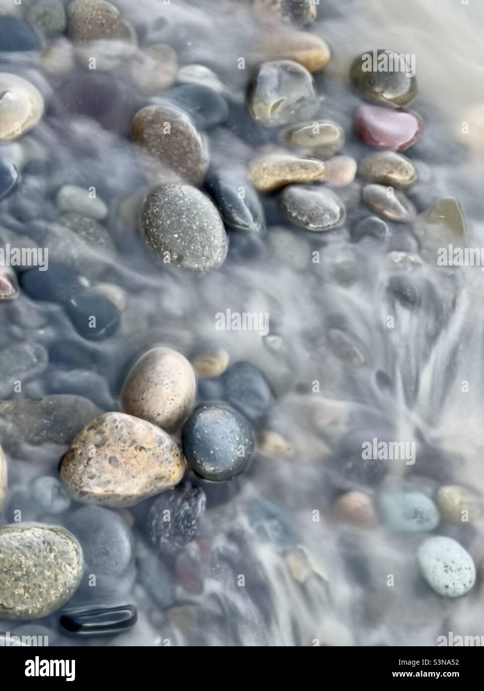 Pebbles in a fast moving stream - Smartphone Captured Stock Image