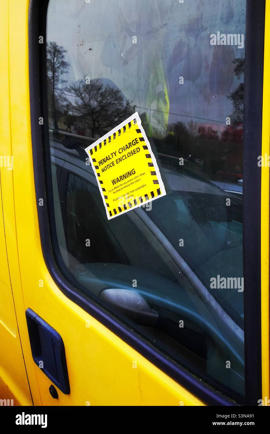 Parking fine penalty charge notice stuck on van driver’s window Stock Photo