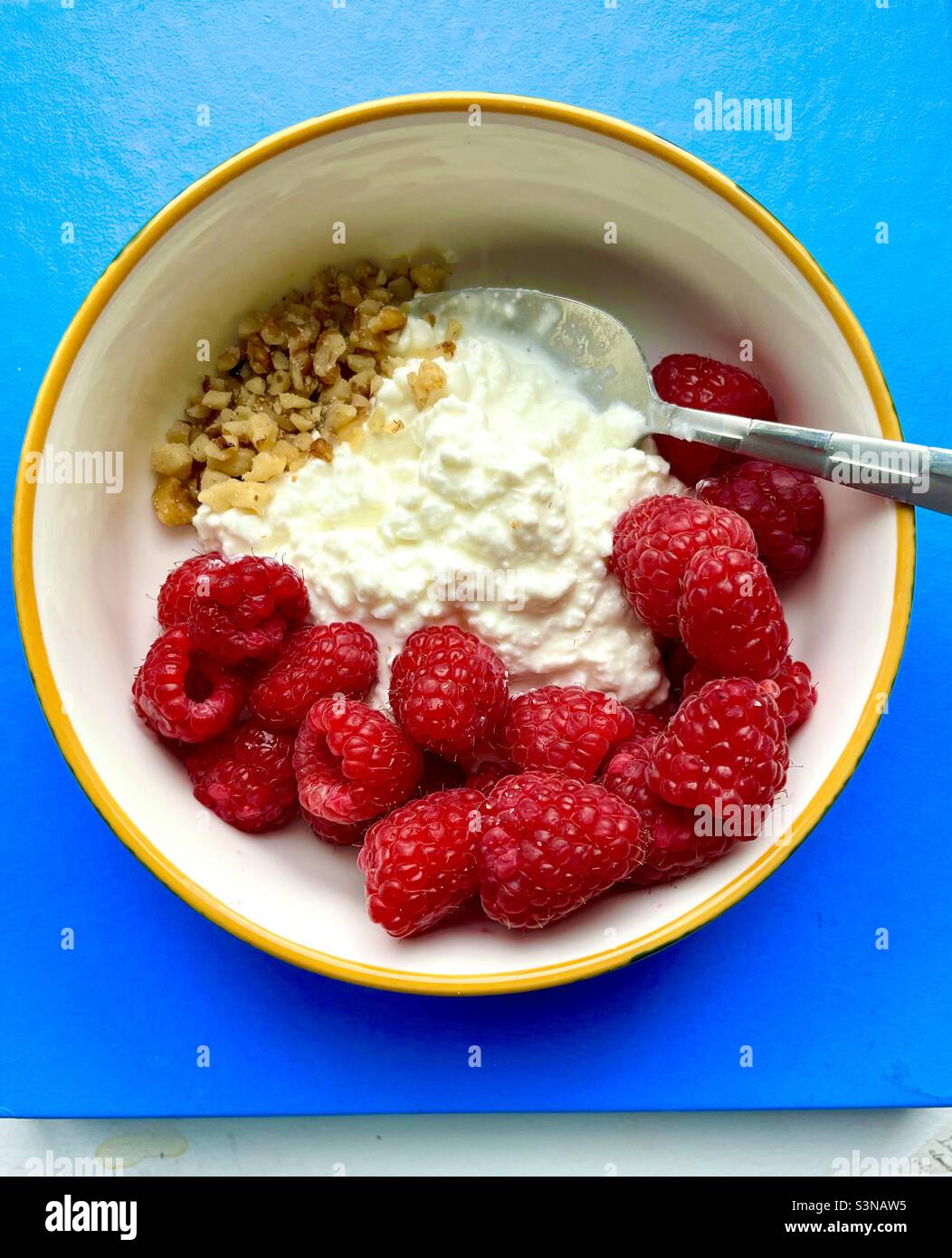 Healthy breakfast bowl of cottage cheese, raspberries, walnuts. - Smartphone Captured Stock Image