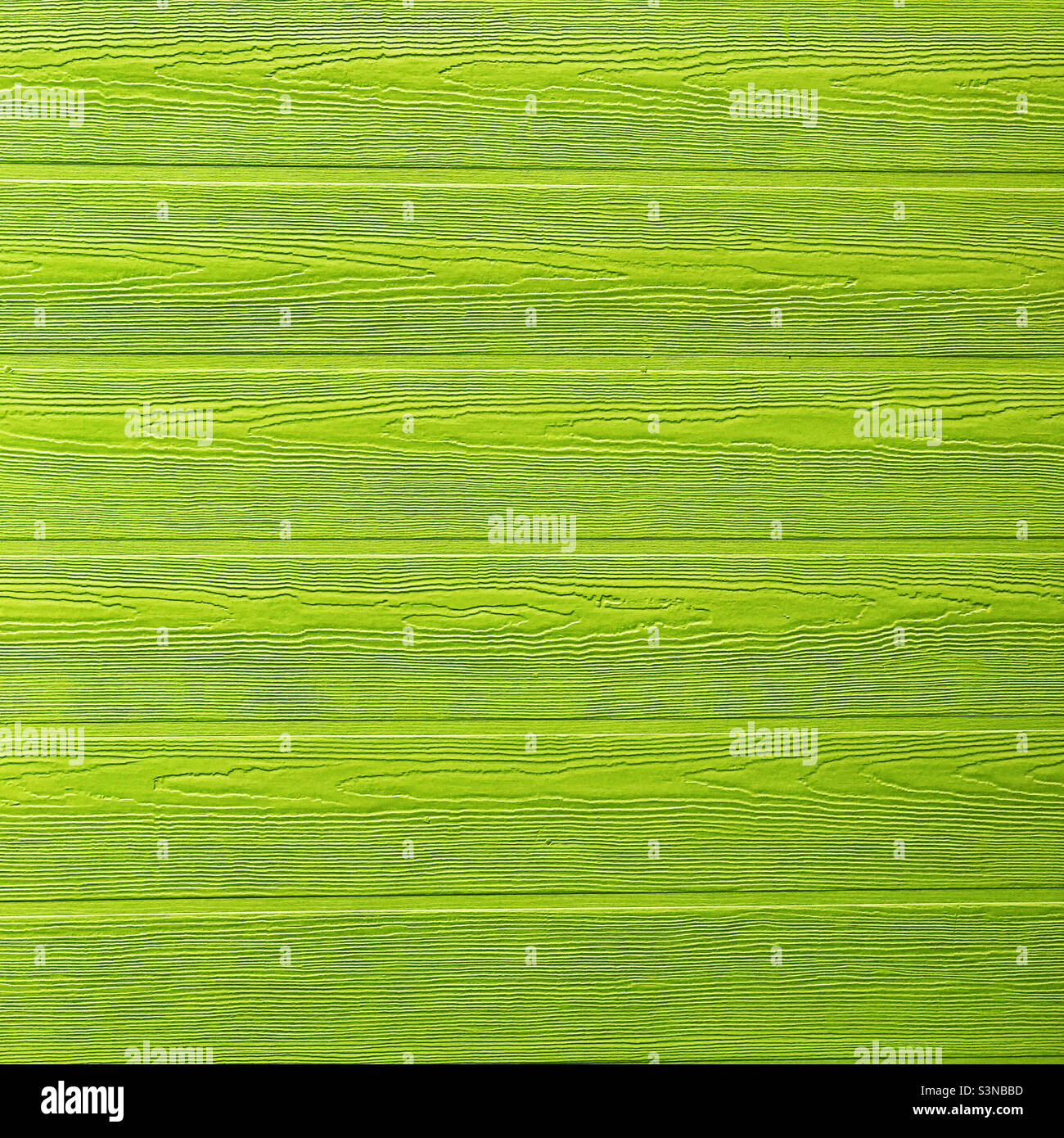 Fresh lime green paint on a wooden wall. Stock Photo
