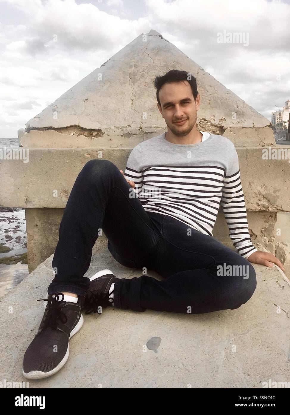 Young man sitting in Melecon, Havana, Cuba. - Smartphone Captured Stock Image