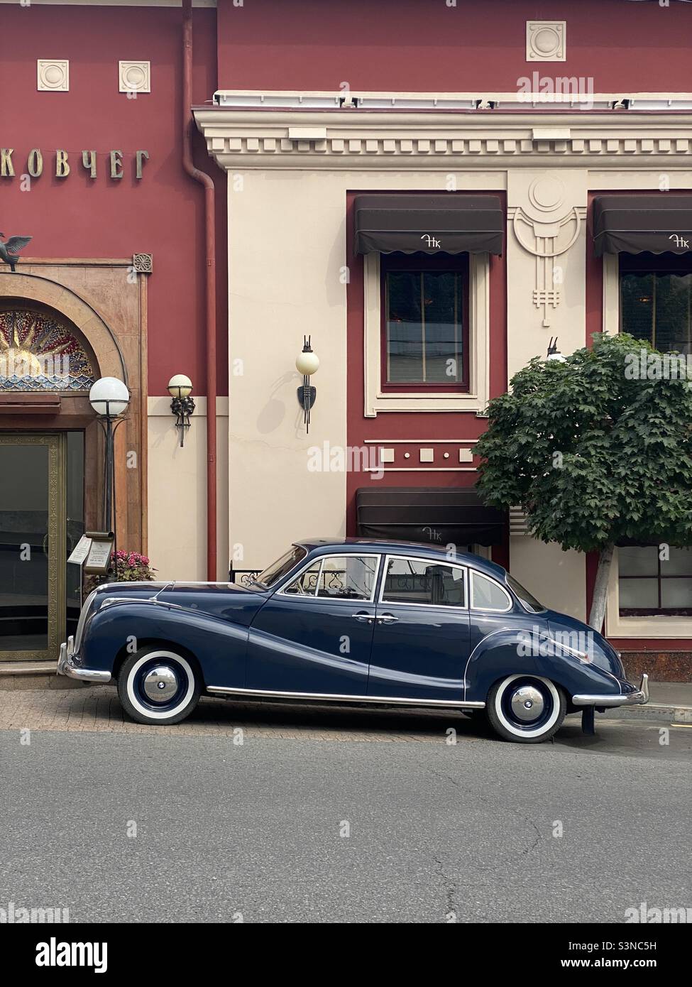 retro car on the background of an old city building - Smartphone Captured Stock Image