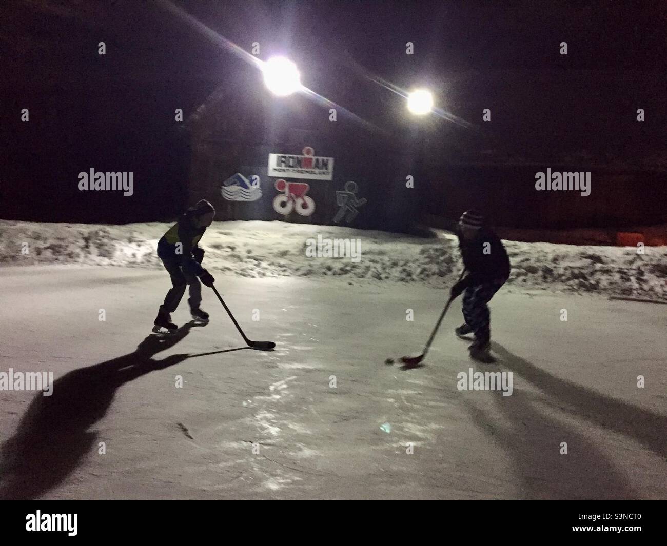 One on one late night hockey game. Stock Photo