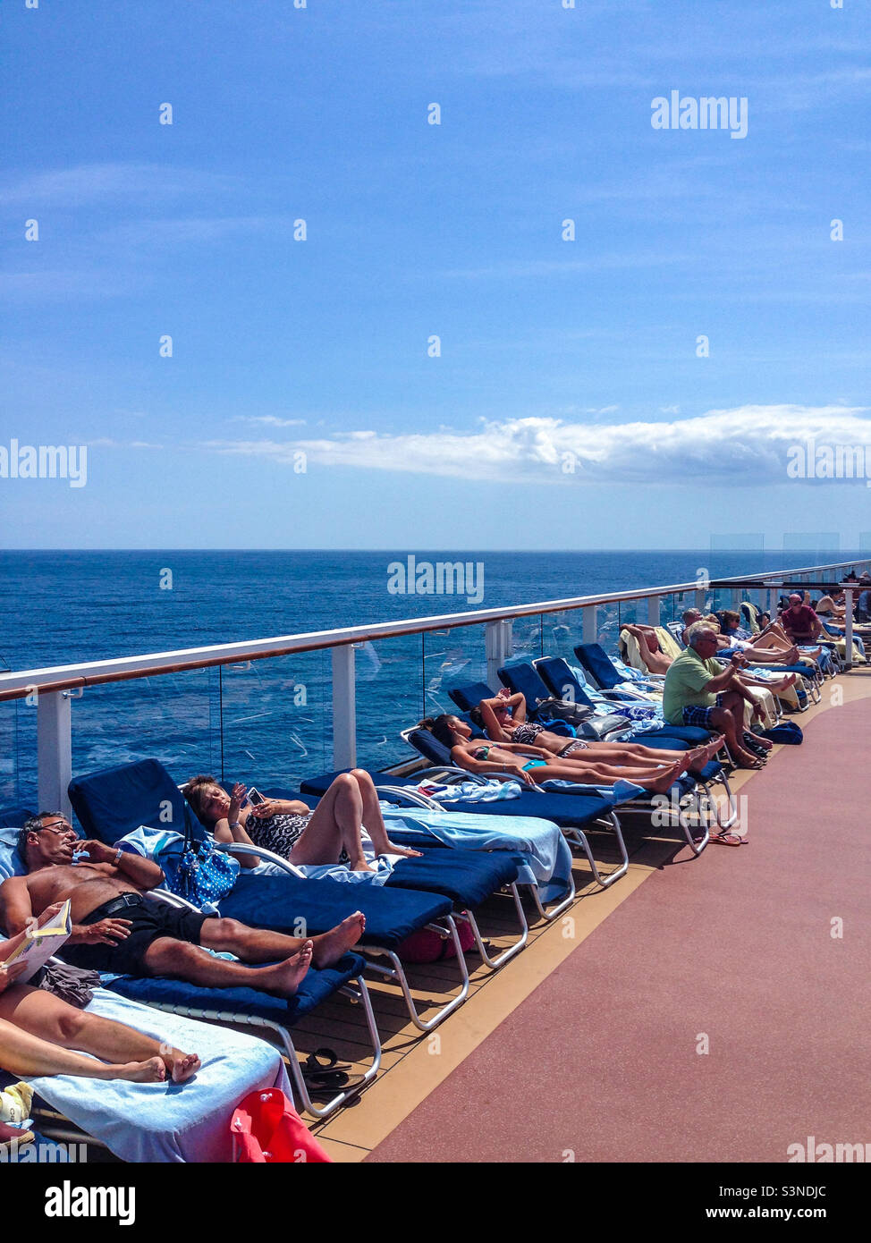 Passengers sunbathing on a cruise ship in the Mediterranean Sea in summer Stock Photo