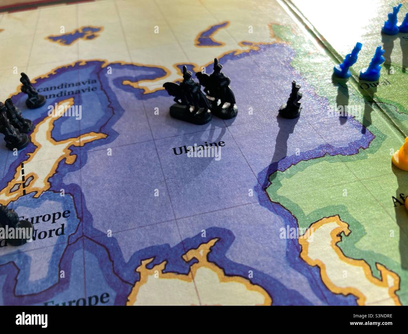 Ukraine on a Risk Board with Black an Blue soldiers - Smartphone Captured Stock Image