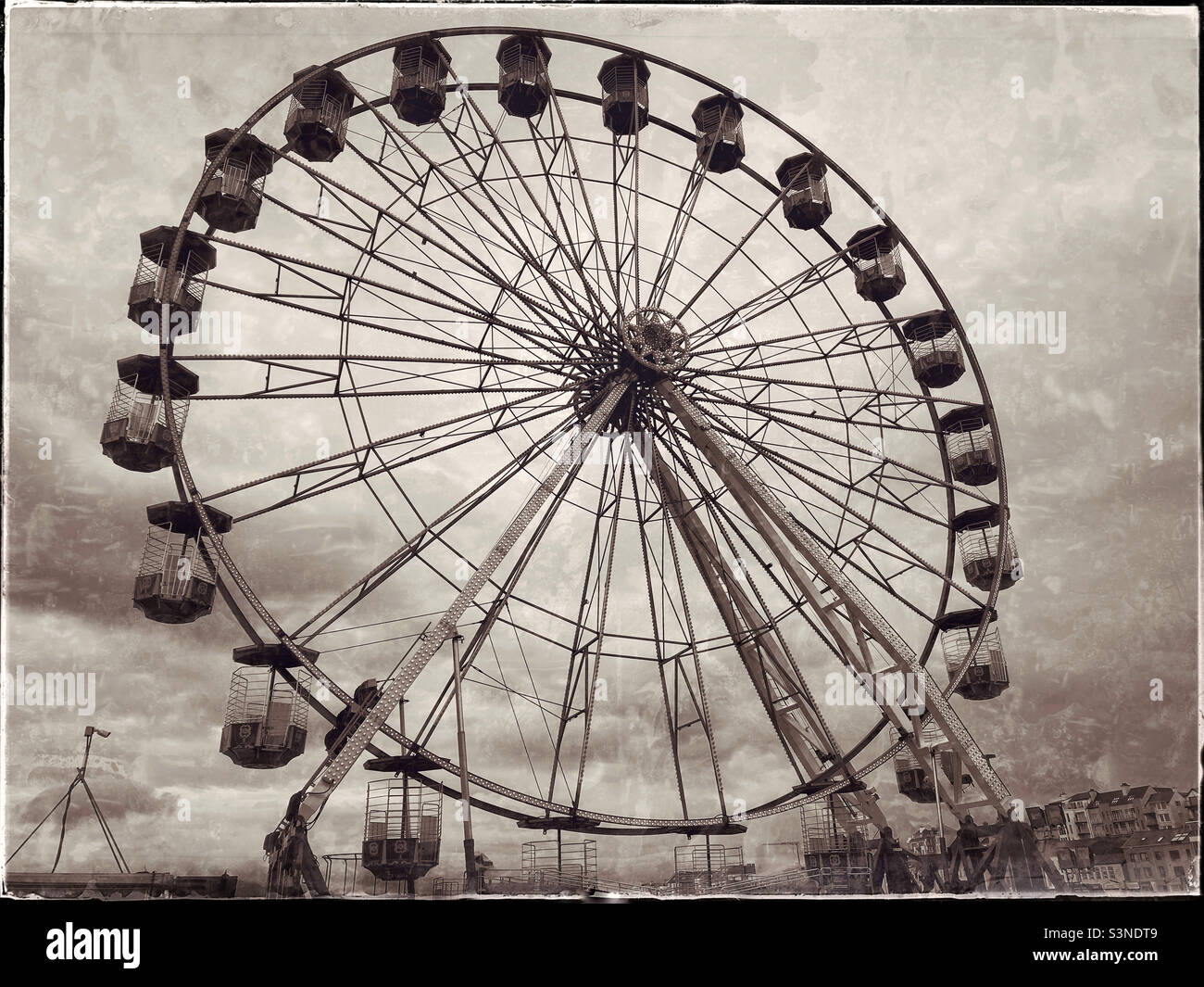 A retro effect image of a Ferris Wheel, sometimes referred to as The Big Wheel. Photo ©️ COLIN HOSKINS. Stock Photo