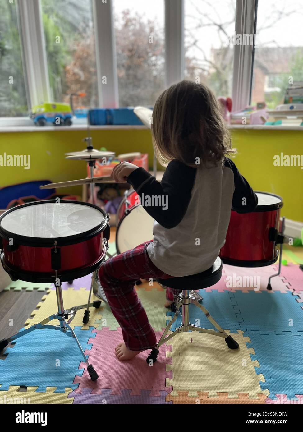 Young boy playing a drum kit Stock Photo