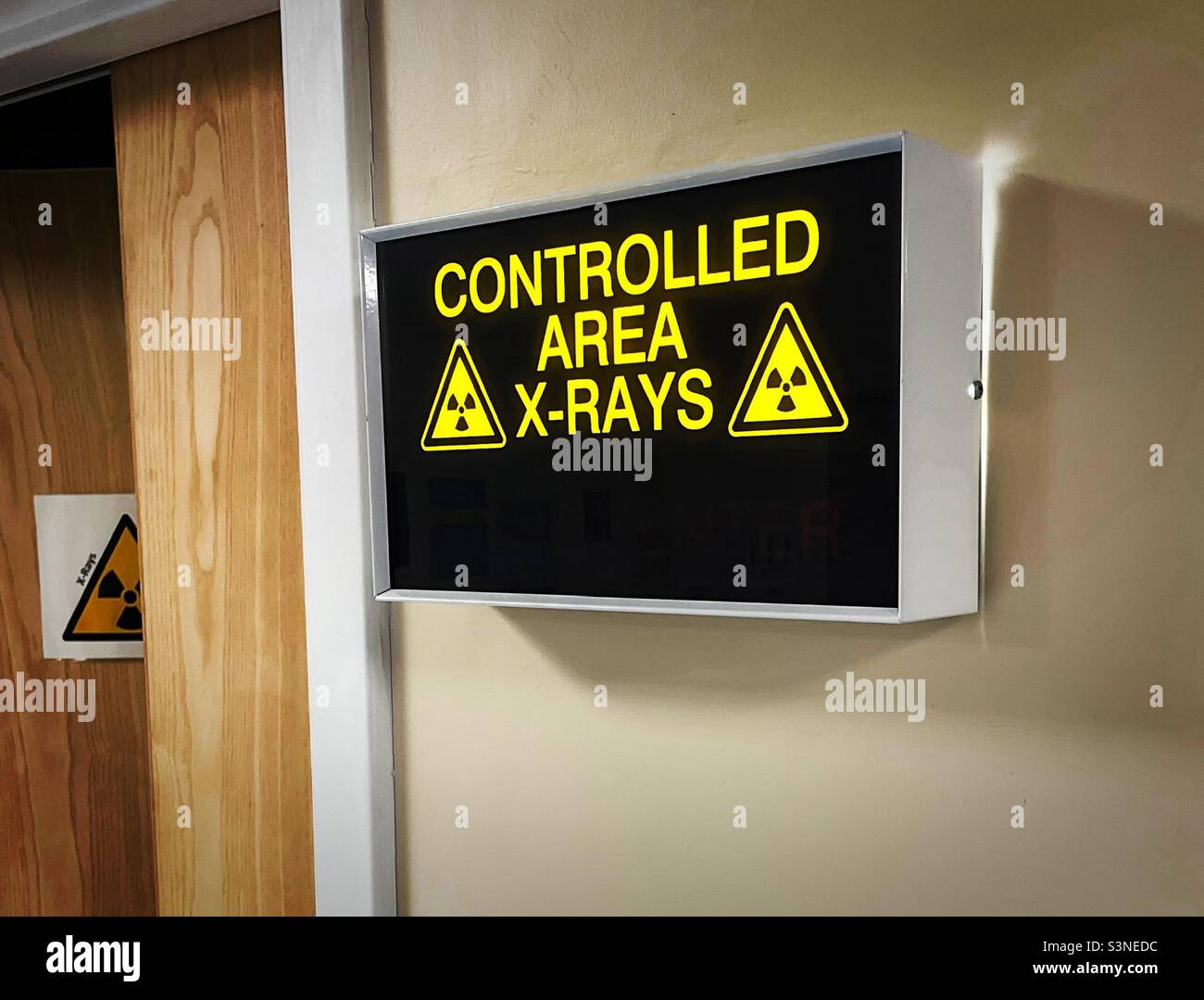 ‘INJURY!’ a warning sign of a Controlled Area where X-Rays take place in a Hospital Stock Photo