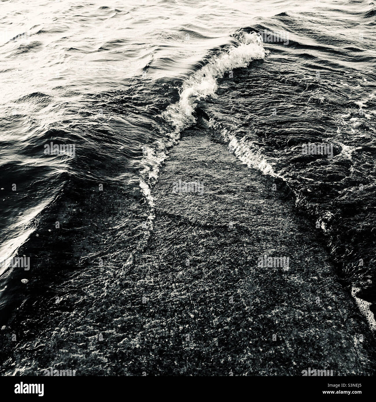 Black and white seascape with waves breaking - Smartphone Captured Stock Image