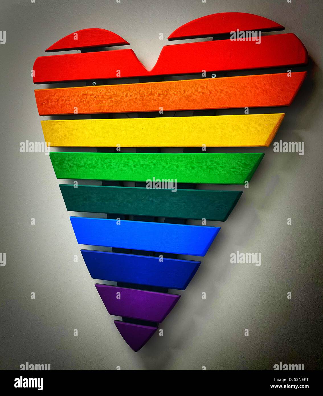 ‘Love for Everyone’ a heart shaped wooden display in the rainbow LGBTQ+ colours to celebrate love for all Stock Photo