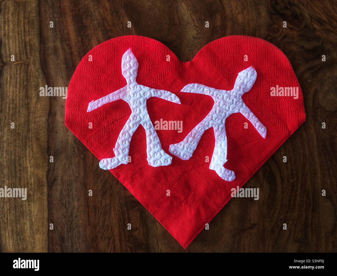Paper cut couple on a heart shaped paper - Smartphone Captured Stock Image