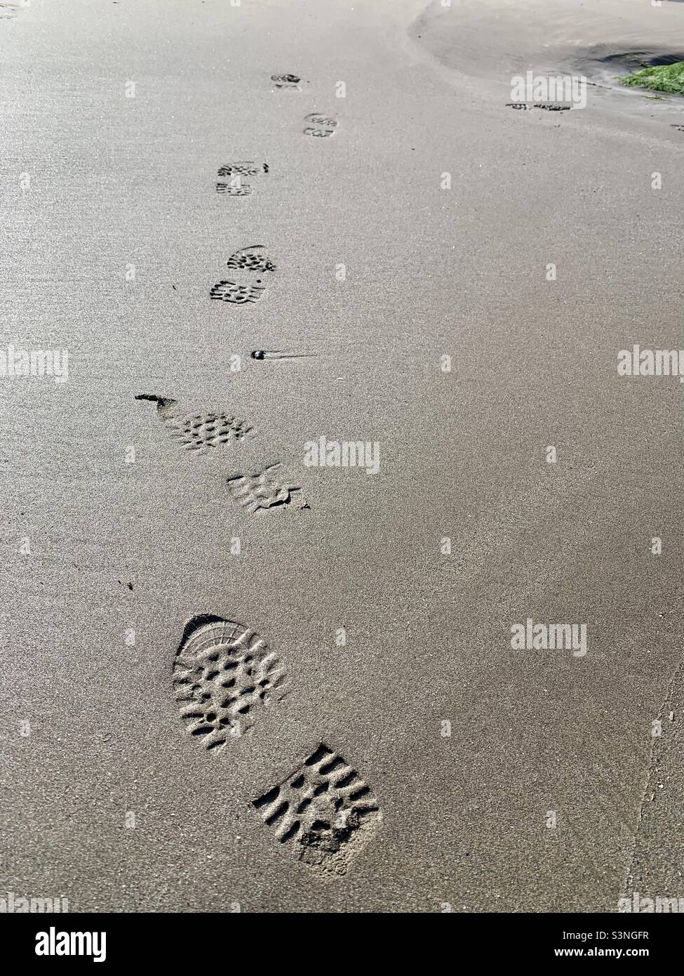 Footprints on a sandy beach Stock Photo