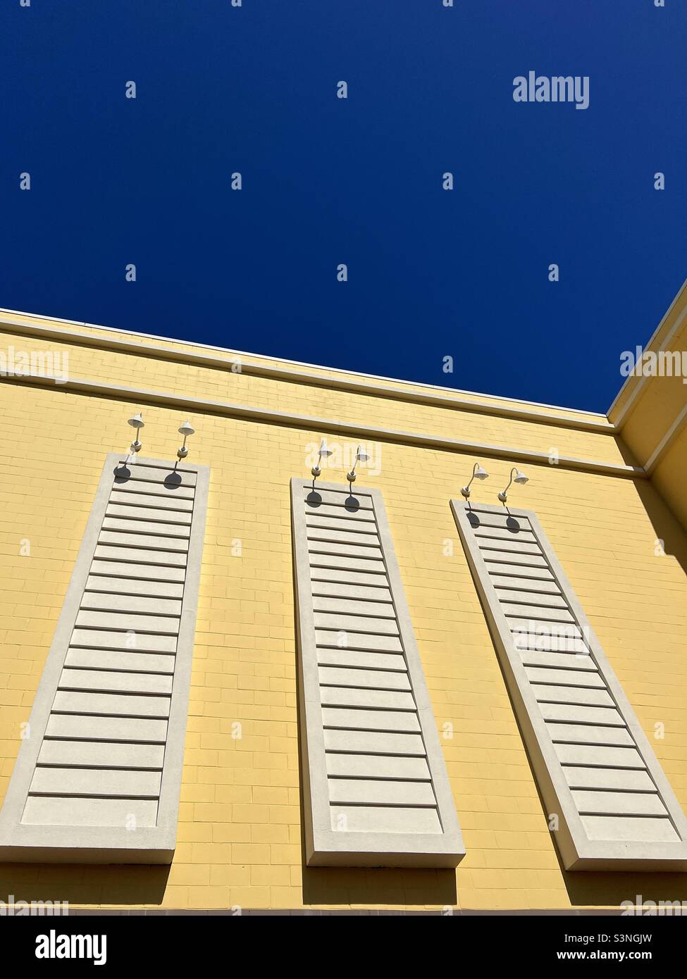 Yellow outdoor decorative wall with deep blue sky background - Smartphone Captured Stock Image