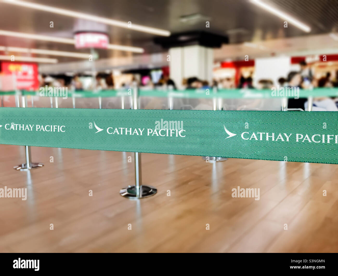Hong Kong, CHN, July 2019: Green belt barrier with white Cathay Pacific airlines logo. Cathay Pacific is the flag carrier airline of Hong Kong. Travel and airport security - Smartphone Captured Stock Image