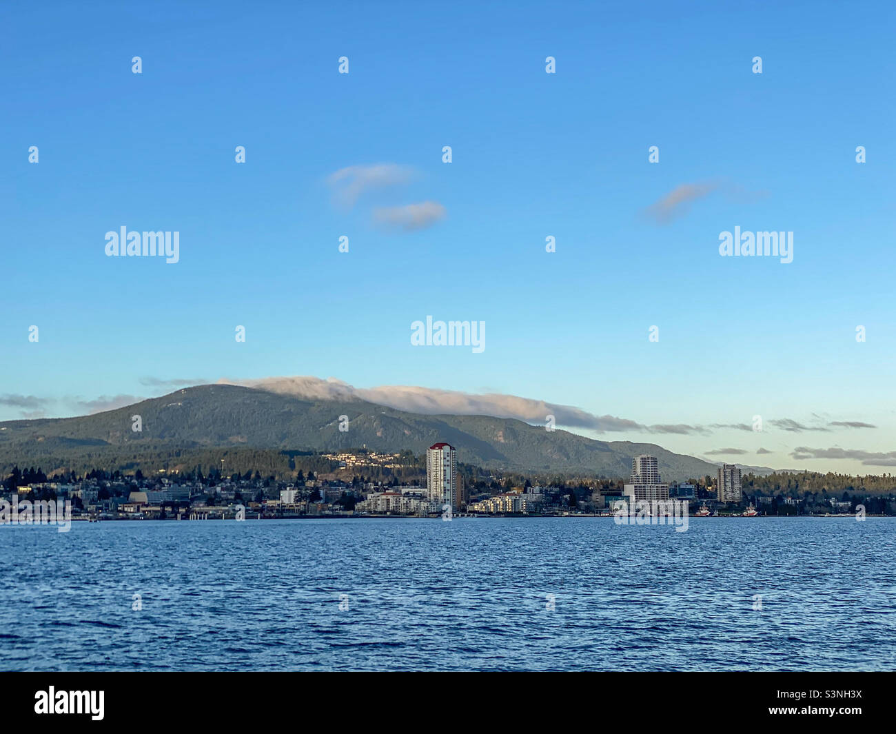 Mount Benson rises behind the waterfront city of Nanaimo on Vancouver Island. The mountain has long been known locally as a “cloud catcher”’. - Smartphone Captured Stock Image