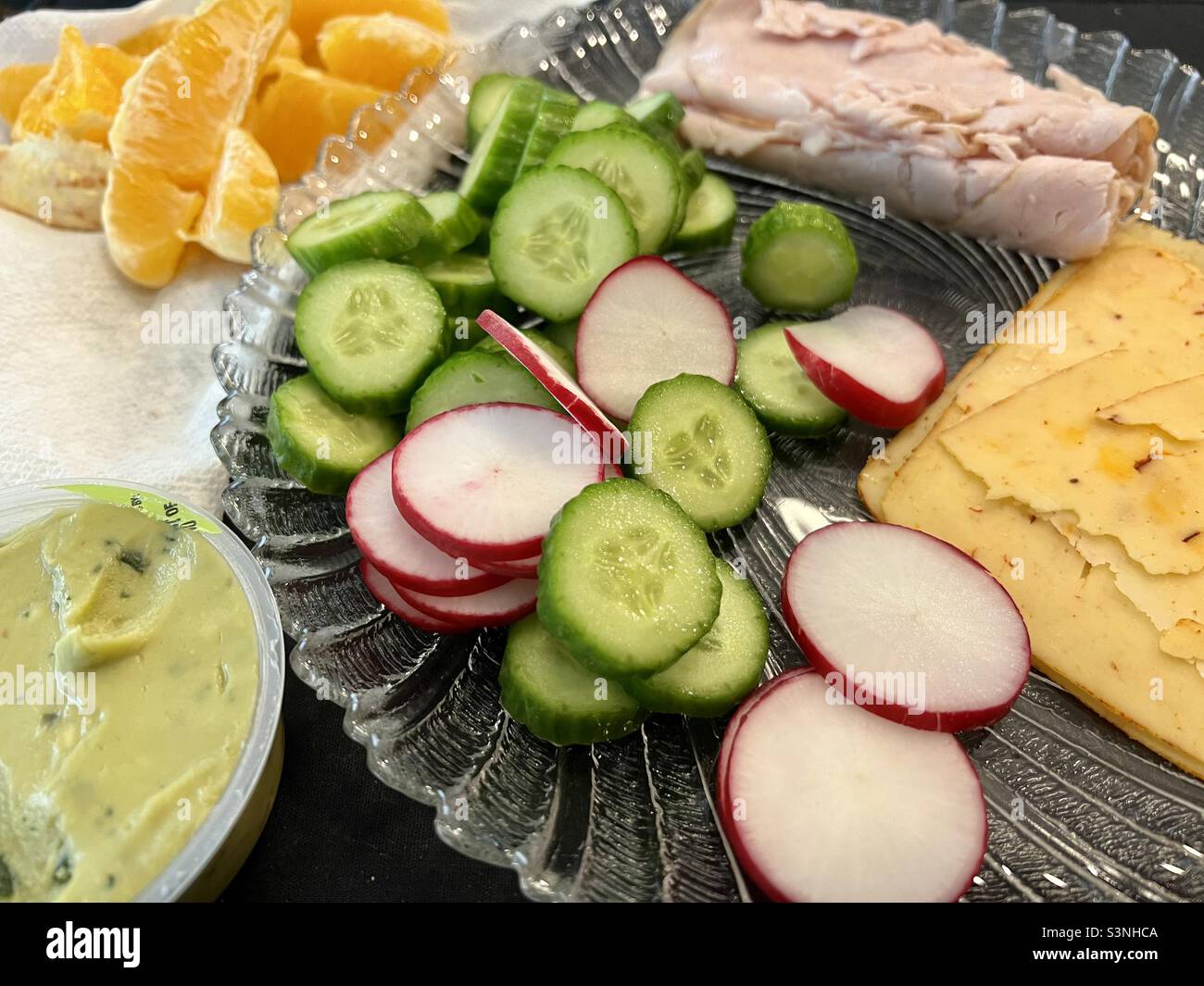 Healthy lunch of turkey, sliced cheese, cucumber, radishes, single