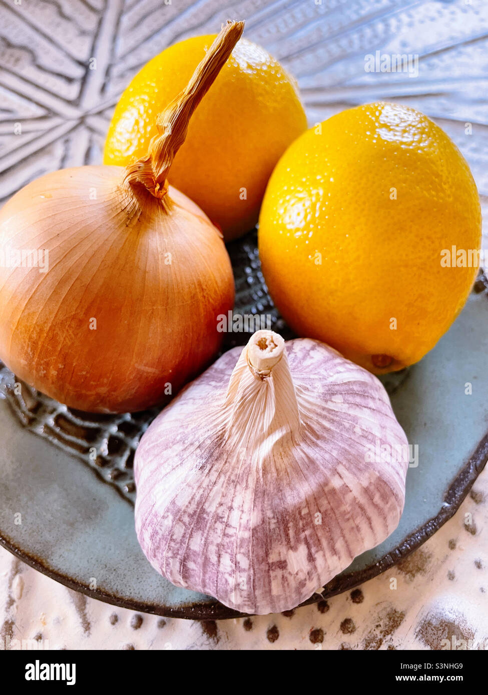 Still life of a plate of lemons, onion and a garlic bulb - Smartphone Captured Stock Image