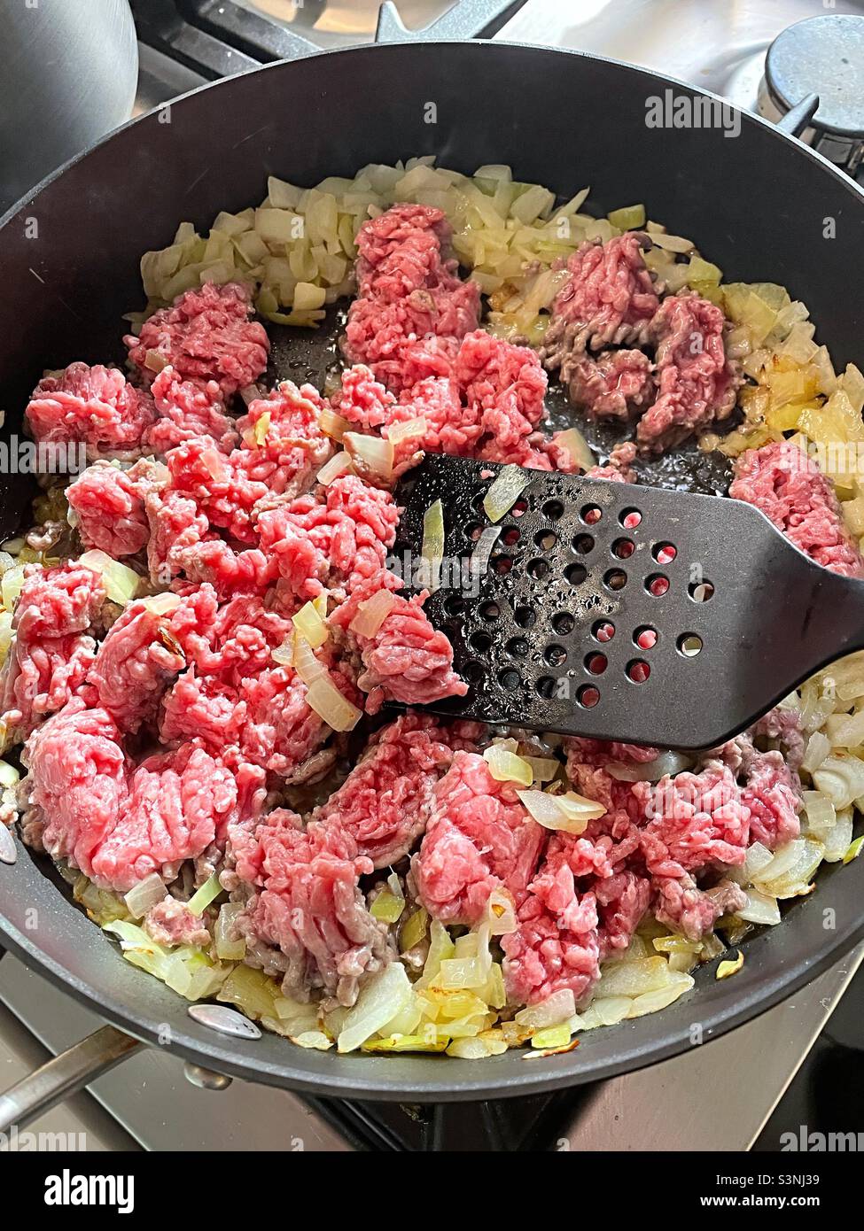 Close-up of a skillet filled with browning ground beef and onions, 2022, USA - Smartphone Captured Stock Image