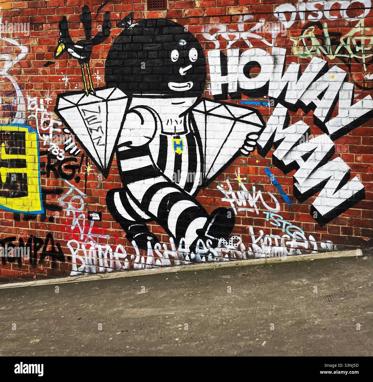 ‘Howay Man’ street art graffiti on a red brick wall in Ouseburn, Newcastle Upon Tyne Stock Photo