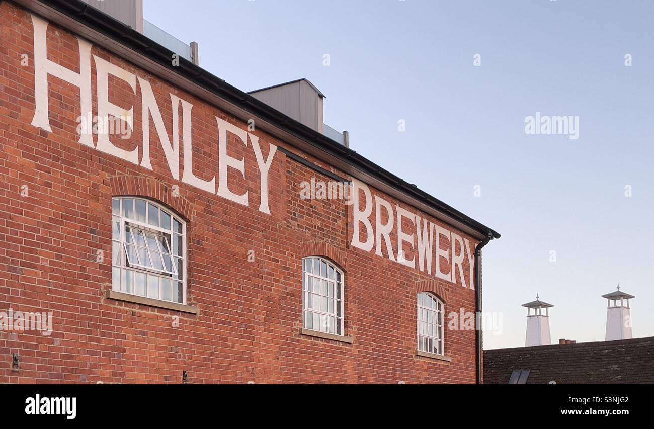 The side of an old Brewery building in Henley on Thames, The inscription reads Henley Brewery The tops of two oast houses in the distance - Smartphone Captured Stock Image
