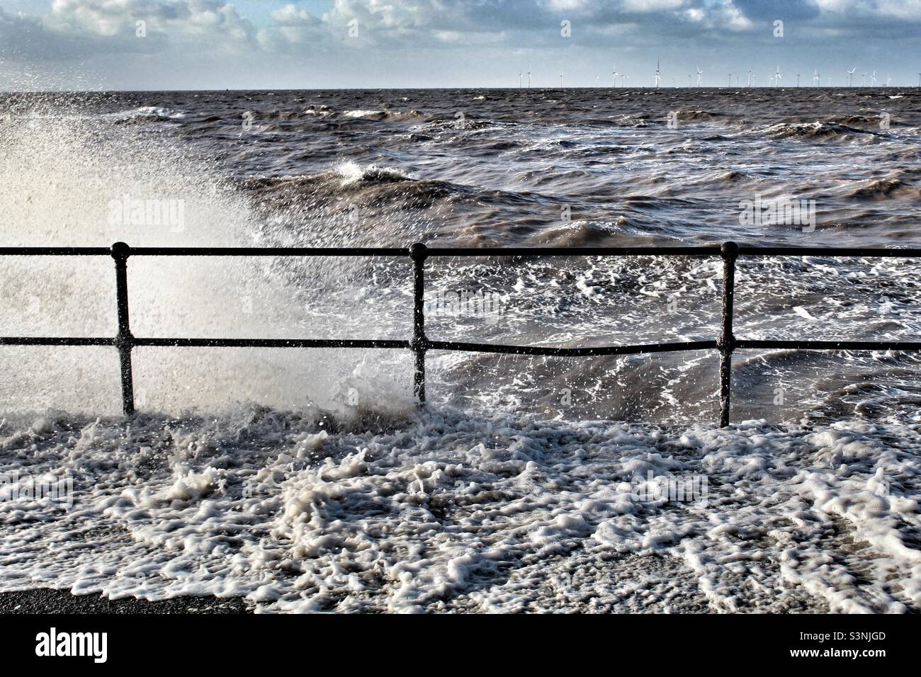 The sea crashing against the beach during Storm Eunice at Crosby Beach in Liverpool, Merseyside - Smartphone Captured Stock Image