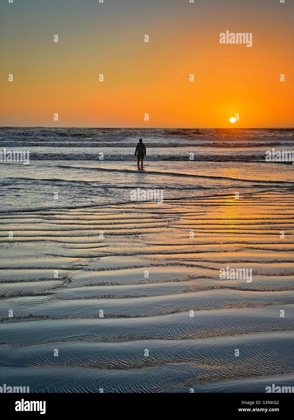 Winter sunset paddle at Rest Bay, South Wales, February. Stock Photo