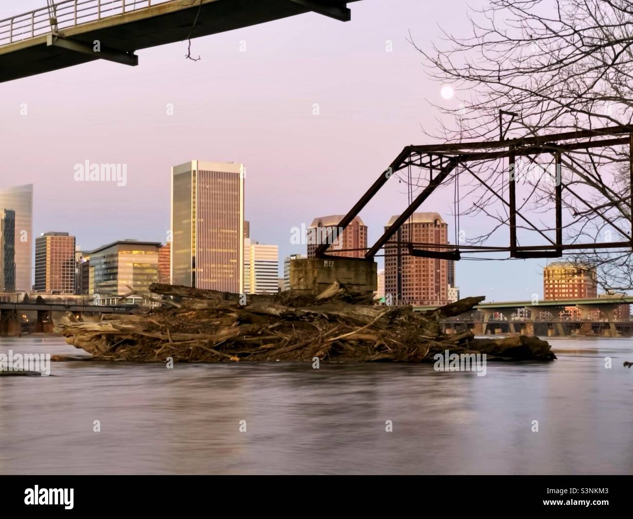 Richmond skyline over the James River shot at golden hour and a full moon. Stock Photo