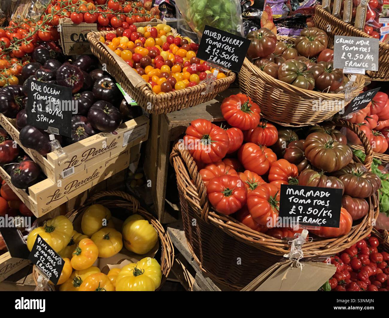 A selection of tomato varieties on display for sale at Bayley & Sage shop in Battersea, London, England. Stock Photo