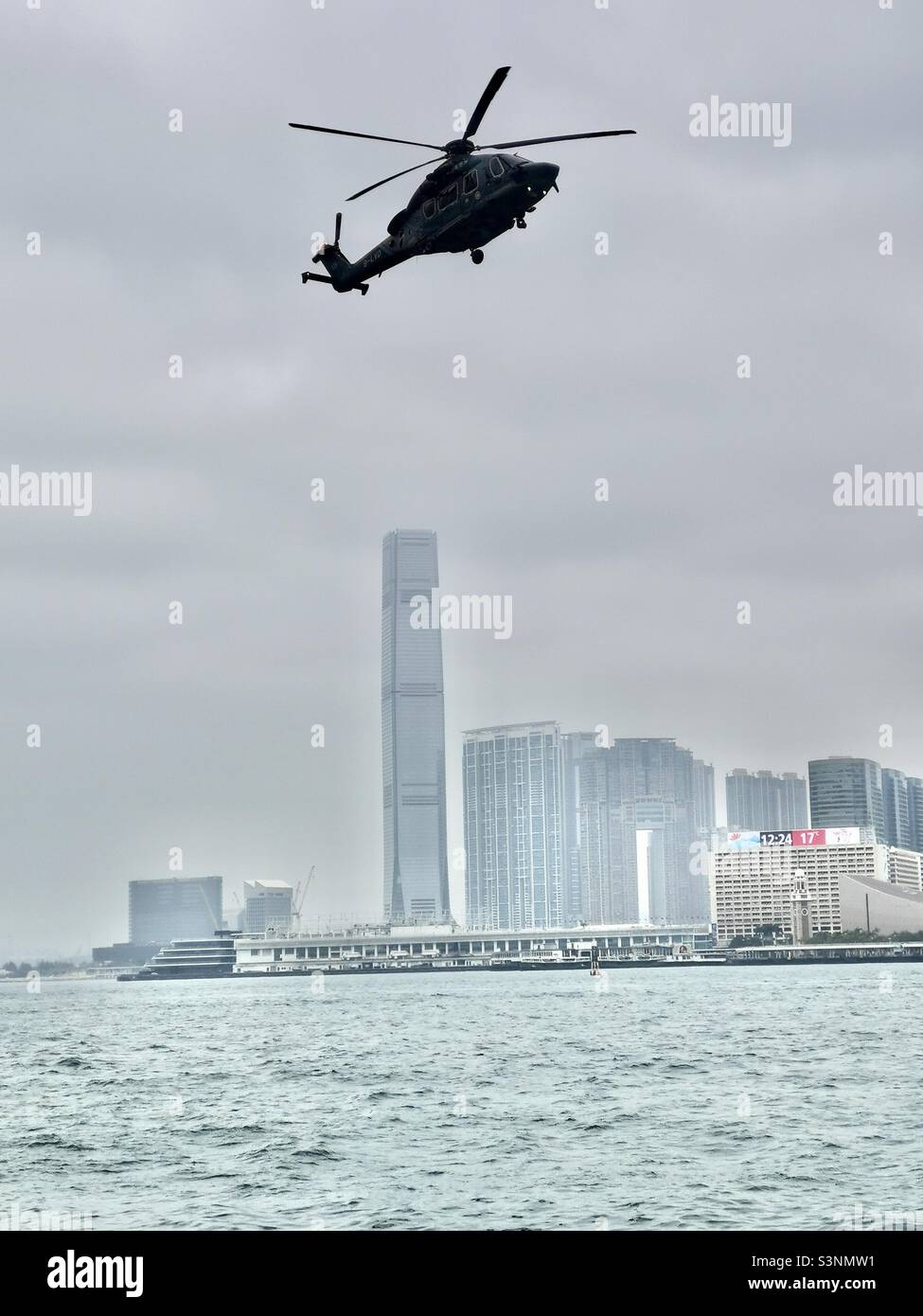 A chopper landing at the helipad in Wan Chai by Victoria harbour in Hong Kong. - Smartphone Captured Stock Image