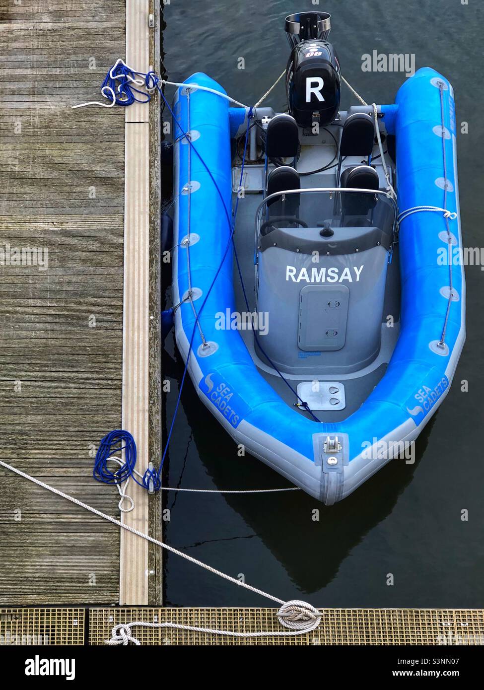 Inflatable Outboard motor boat moored in harbour - Smartphone Captured Stock Image
