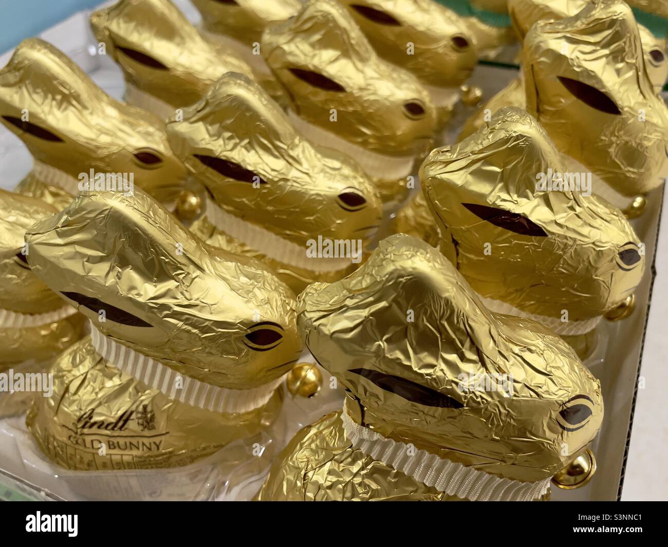 Rows of foil-wrapped chocolate Easter bunnies for sale in a Worcester supermarket - Smartphone Captured Stock Image