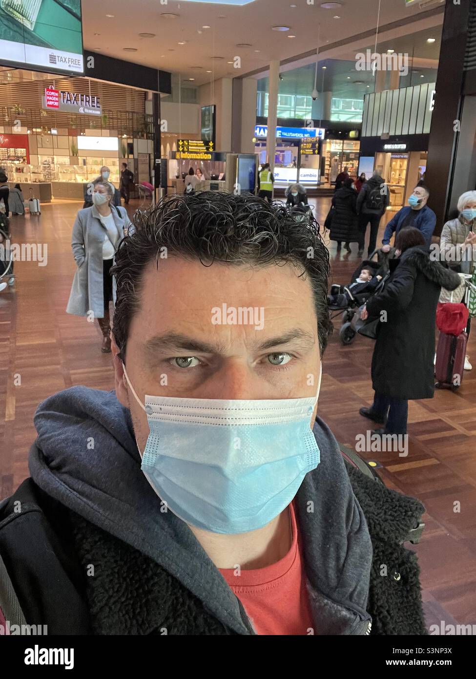 Man at an airport wearing a face mask - Smartphone Captured Stock Image